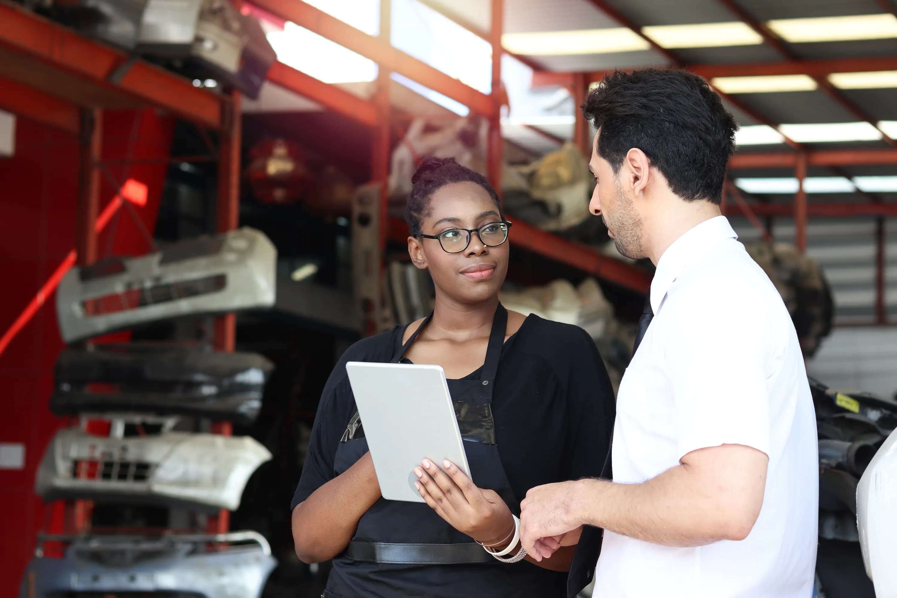 Auto shop technician with customer.webp